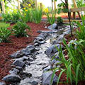 rock lined drainage swale from parking lot